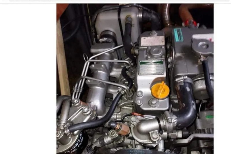 Slide: The Image of Engine of a 2006 Lagoon 410-S2 catamaran, showcasing intricate mechanical components. - 39