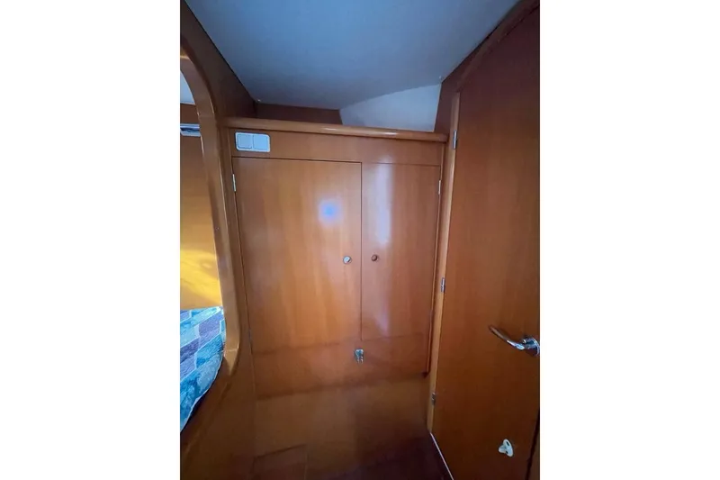 Slide: The Image of Interior of 2006 Lagoon 410-S2 yacht with wooden cabinetry and door. - 8