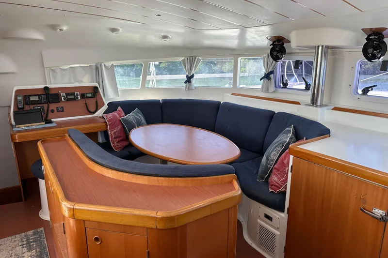 Slide: The Image of Interior of 2006 Lagoon 410-S2 yacht with cozy seating and navigation area. - 9