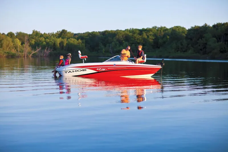 Slide: The Image of 2013 Tahoe Q5 SF boat with yellow and white interior, parked outdoors near buildings. - 3
