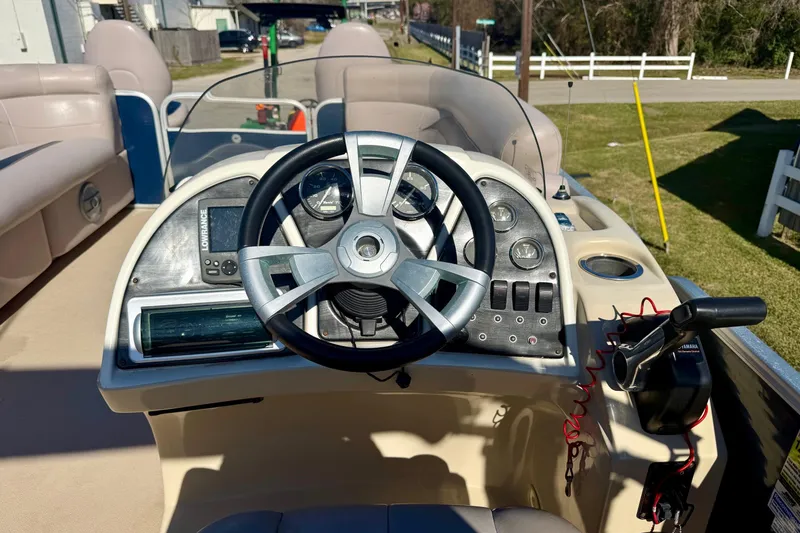 Slide: The Image of Steering console of a 2015 Sweetwater 2286 BF boat with gauges and controls. - 10