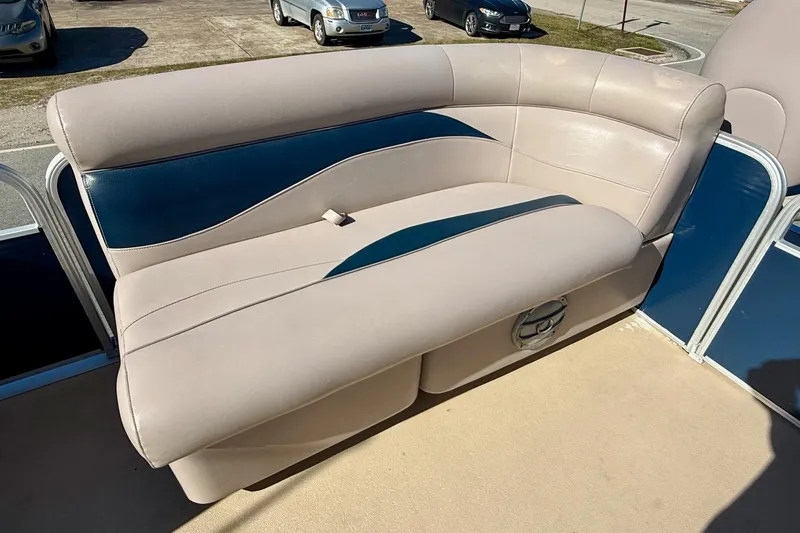 Slide: The Image of 2015 Sweetwater 2286 BF boat seating with beige and blue upholstery. - 12