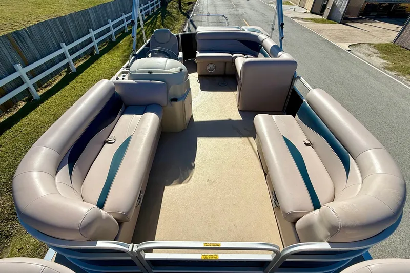 Slide: The Image of 2015 Sweetwater 2286 BF pontoon boat with spacious seating and beige upholstery. - 14
