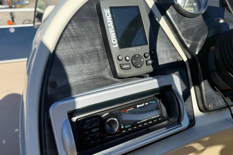 Slide: The Image of Control panel of a 2015 Sweetwater 2286 BF boat with Lowrance Elite-4 and Boss Marine stereo. - 17