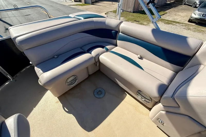 Slide: The Image of 2015 Sweetwater 2286 BF boat interior with beige and blue cushioned seating. - 7