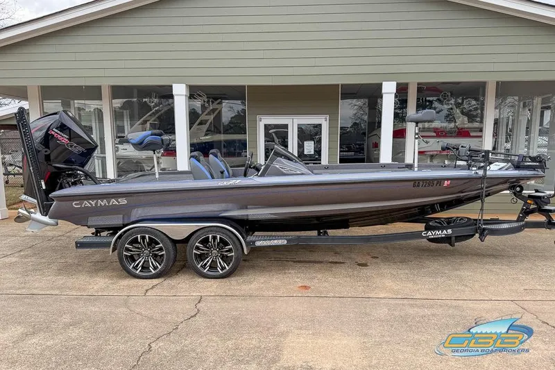 The Image of 2023 Caymas CX 21 PRO boat on trailer, parked outside a building. - 0
