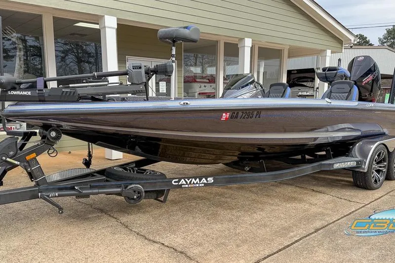 Slide: The Image of 2023 Caymas CX 21 PRO boat on trailer, parked outside a building. - 1