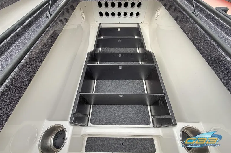 Slide: The Image of 2023 Caymas CX 21 PRO boat storage compartments with cup holders and organized layout. - 21