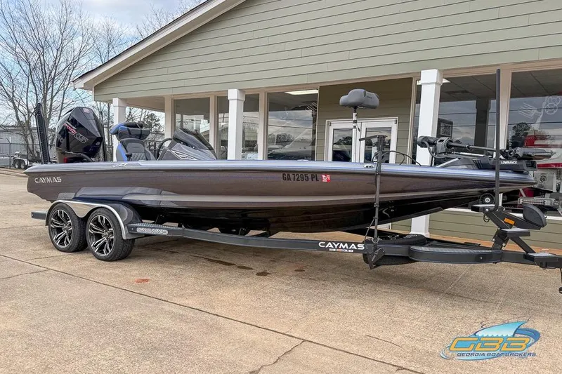 Slide: The Image of 2023 Caymas CX 21 PRO boat on trailer outside a showroom. - 3