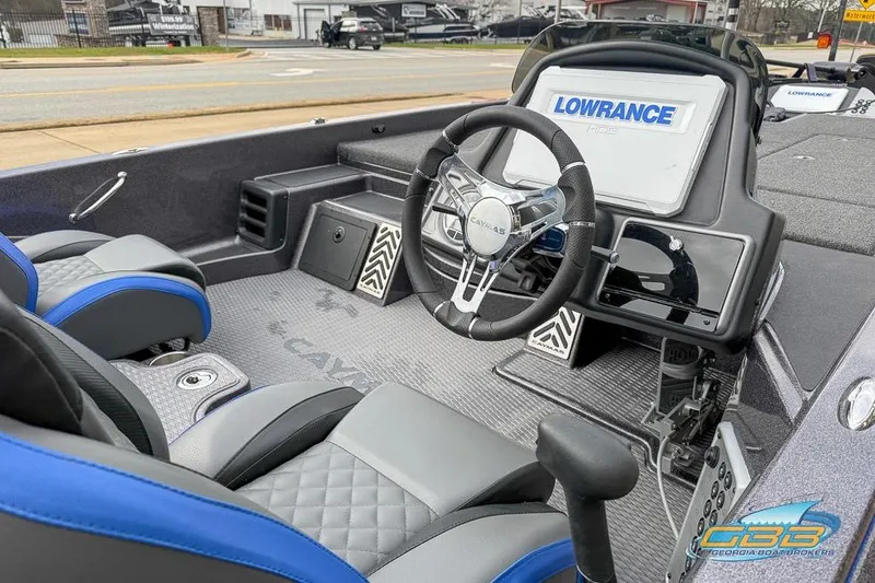 Slide: The Image of 2023 Caymas CX 21 PRO boat interior with steering wheel and Lowrance display. - 6