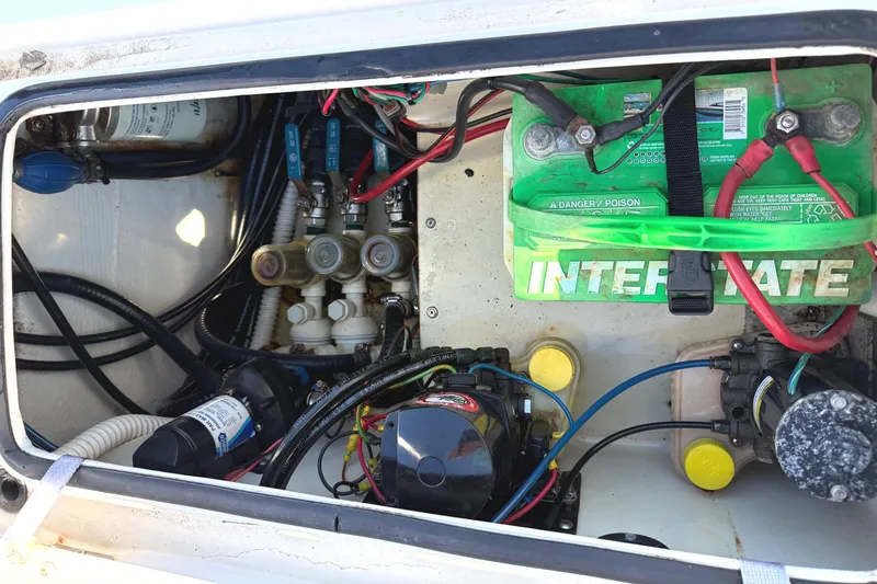 Slide: The Image of 2008 Pathfinder 2200 Tournament Edition boat battery and wiring compartment. - 13