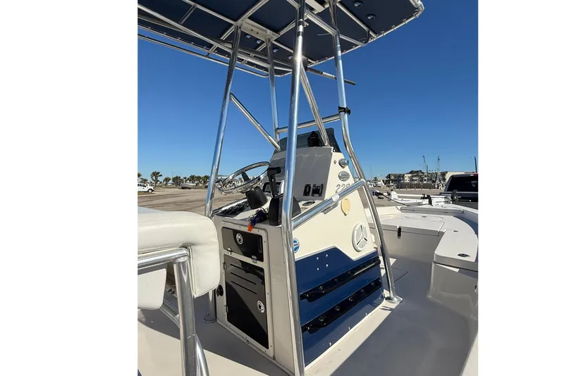 Slide: The Image of 2008 Pathfinder 2200 Tournament Edition boat console with T-top and clear blue sky. - 4