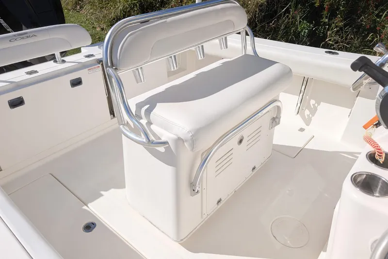 Slide: The Image of 2019 Cobia 237 Center Console boat interior with white seating and storage. - 10