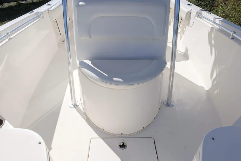 Slide: The Image of 2019 Cobia 237 Center Console boat interior with seating and storage. - 12