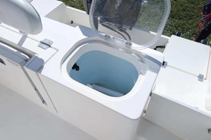Slide: The Image of 2019 Cobia 237 Center Console boat with open storage compartment. - 14