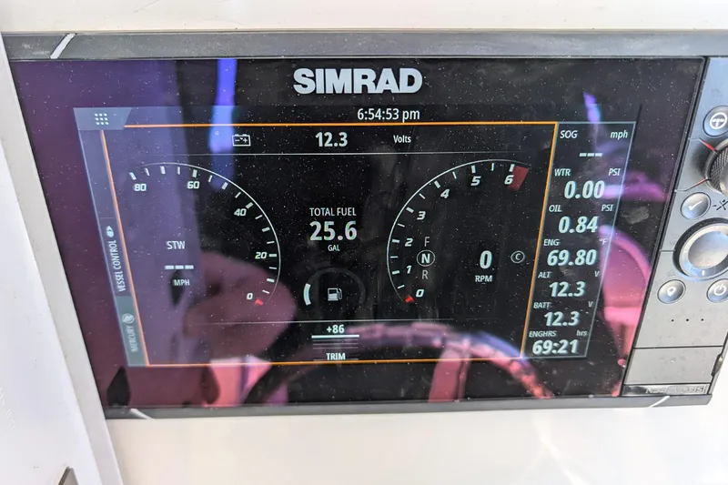 Slide: The Image of Simrad display on 2019 Cobia 237 Center Console showing fuel, speed, and engine data. - 15