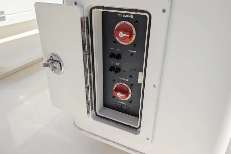 Slide: The Image of Control panel on a 2019 Cobia 237 Center Console boat, featuring 12V engine switches. - 17