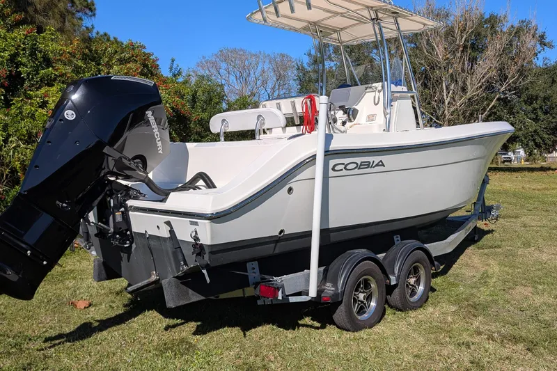 Slide: The Image of 2019 Cobia 237 Center Console boat on trailer, featuring Mercury outboard motor. - 5