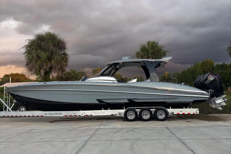 The Image of 2020 MTI V42 boat on trailer with stormy sky background. - 1