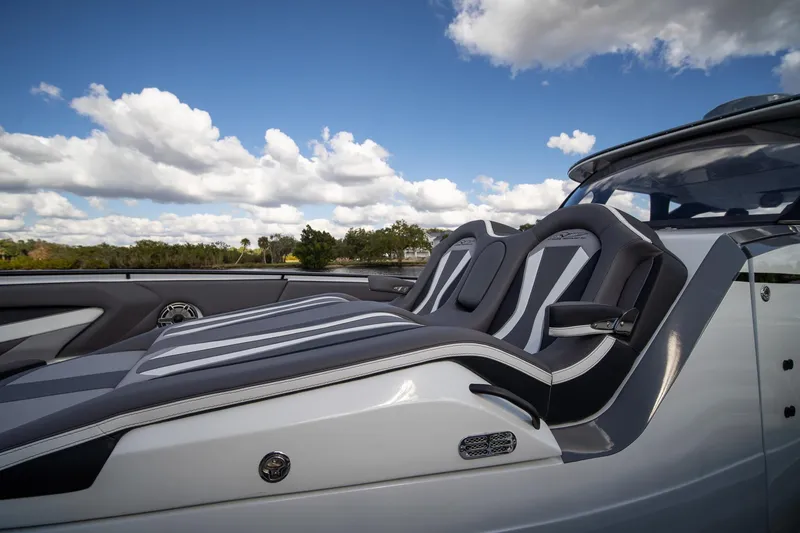 Slide: The Image of Luxury seating on MTI V42 boat, 2020 model, under a blue sky with clouds. - 11