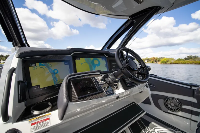 Slide: The Image of Cockpit of 2020 MTI V42 boat with navigation screens and steering wheel. - 15