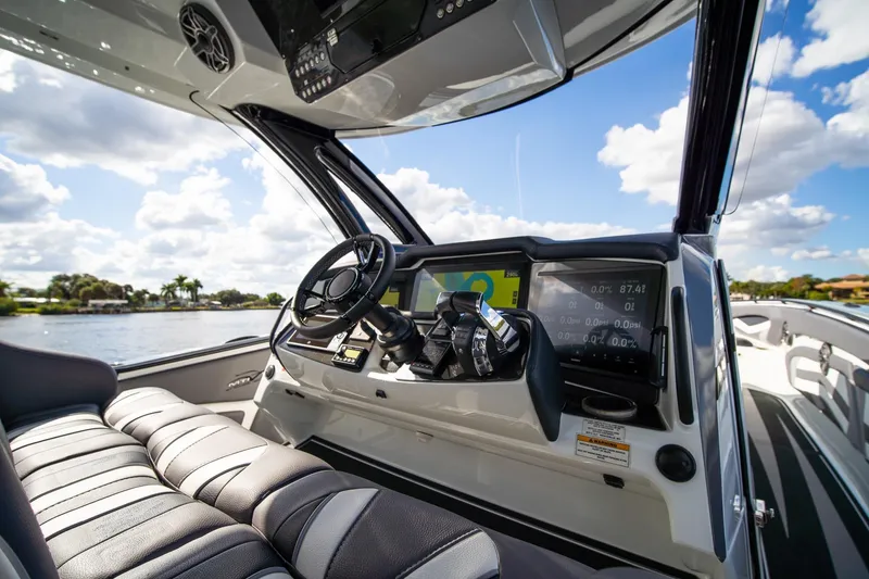 Slide: The Image of Interior view of 2020 MTI V42 boat cockpit with steering wheel and digital displays. - 18