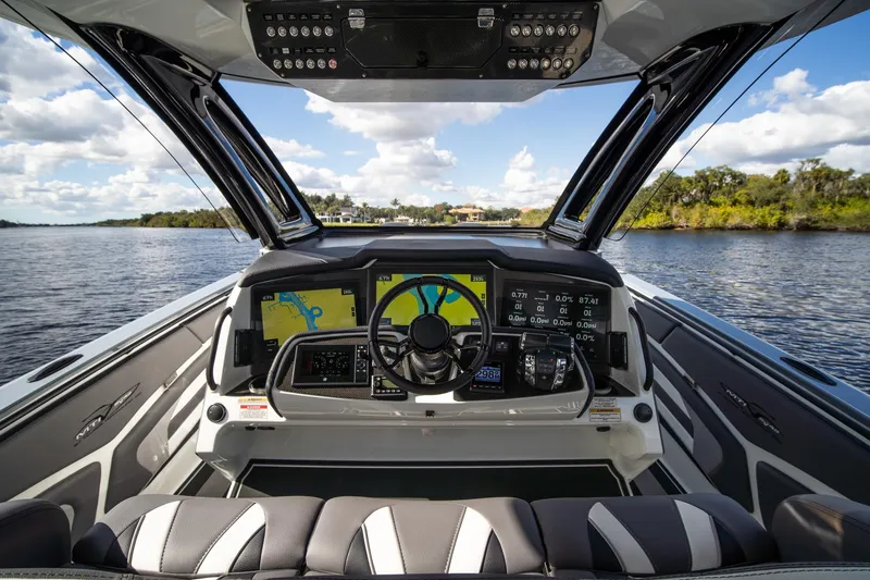 Slide: The Image of Cockpit view of 2020 MTI V42 boat with advanced navigation system on a scenic waterway. - 19