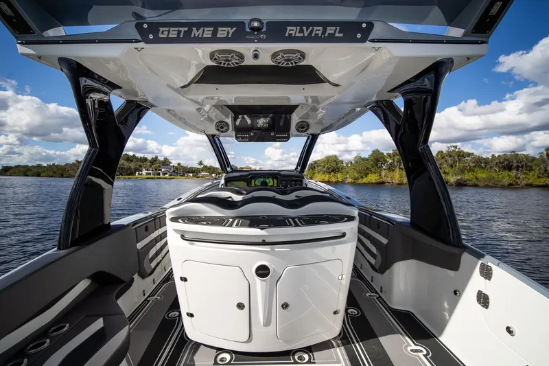 Slide: The Image of Luxury MTI V42 boat interior with sleek design, on a scenic waterway, under a blue sky. - 20