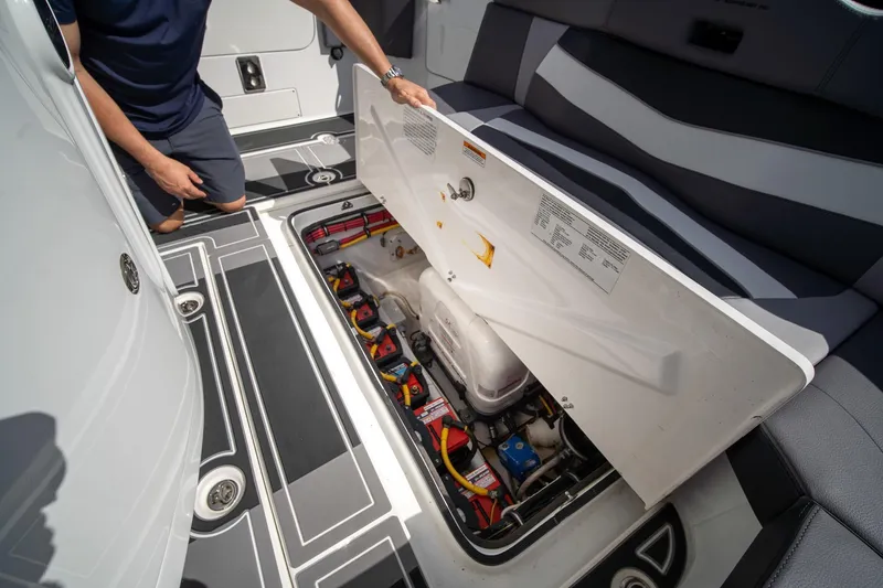 Slide: The Image of 2020 MTI V42 boat showing open hatch with battery compartment and wiring. - 24