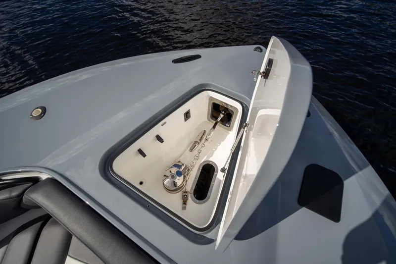 Slide: The Image of Open anchor compartment on 2020 MTI V42 boat, with visible chain and winch. - 26