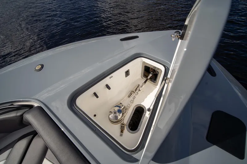 Slide: The Image of Open anchor compartment on MTI V42 boat, 2020 model, with visible chain and water background. - 27