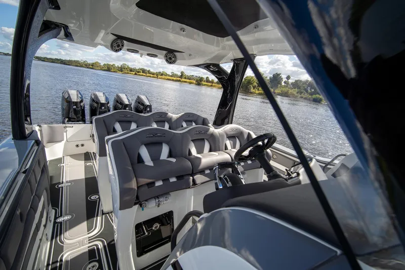 Slide: The Image of Luxury MTI V42 boat interior with multiple seats and steering, 2020 model on a serene lake. - 33