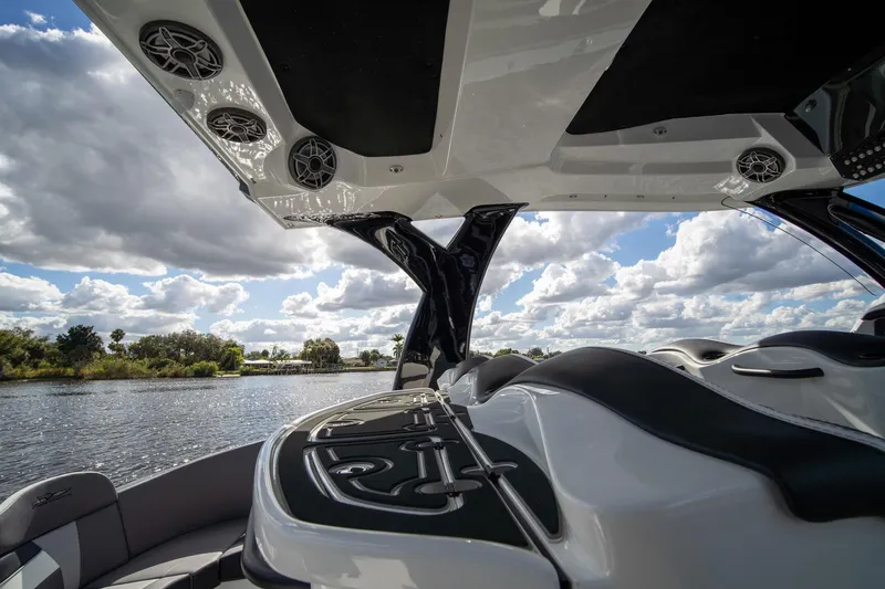 Slide: The Image of Luxury MTI V42 boat interior with sleek design, speakers, and scenic water view. - 34