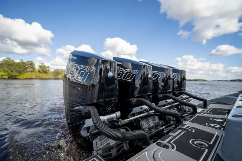 Slide: The Image of Four powerful outboard motors on an MTI V42 boat, 2020 model, cruising on a sunny day. - 37