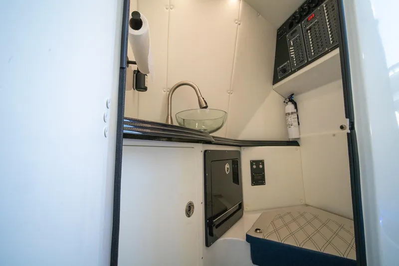 Slide: The Image of 2020 MTI V42 boat interior with sink, control panel, and fire extinguisher. - 42