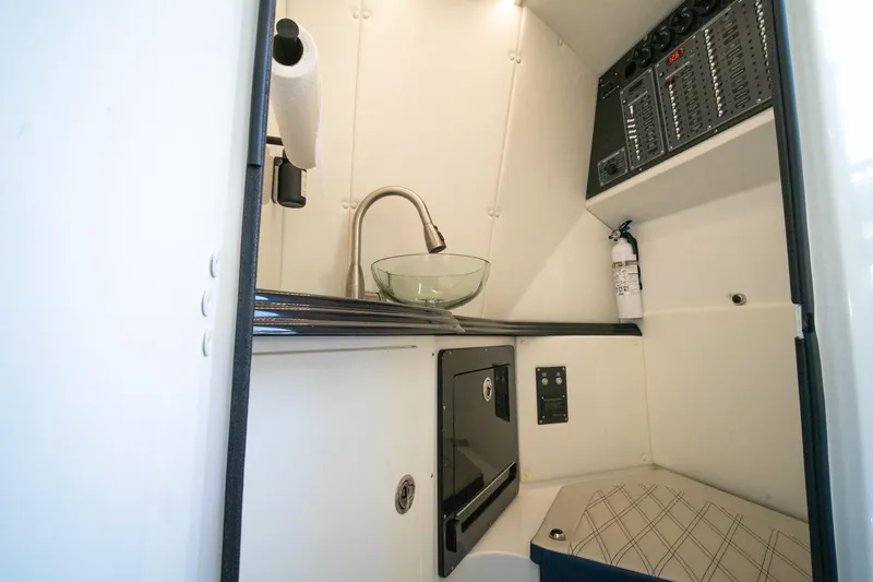 Slide: The Image of Compact boat interior with glass sink, control panel, and fire extinguisher in MTI V42 model. - 43