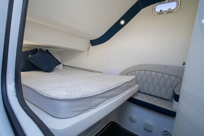 Slide: The Image of 2020 MTI V42 cabin interior with bed, cushions, and seating area. - 44