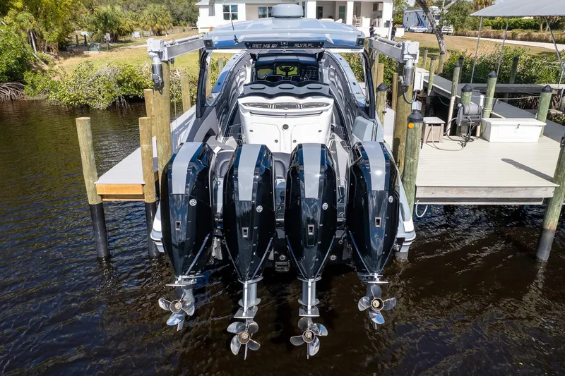 Slide: The Image of 2020 MTI V42 boat with four powerful outboard engines docked at a pier. - 53