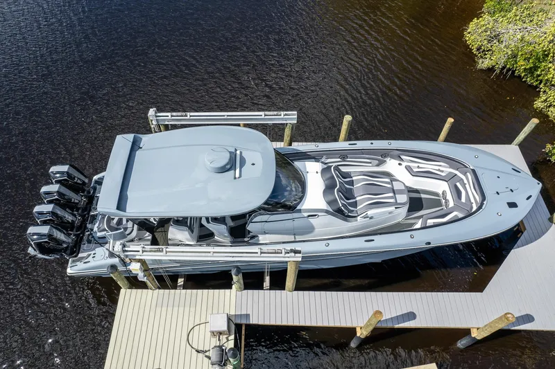 Slide: The Image of Aerial view of a 2020 MTI V42 boat docked, featuring sleek design and multiple engines. - 55