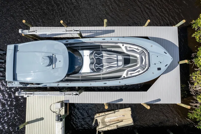 Slide: The Image of Aerial view of a 2020 MTI V42 boat docked on a wooden pier. - 56