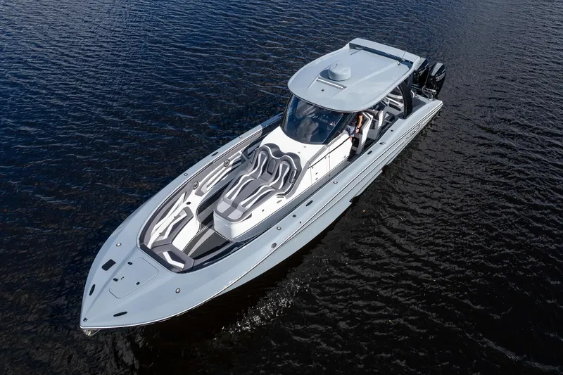 Slide: The Image of 2020 MTI V42 boat cruising on open water, showcasing sleek design and luxury features. - 62