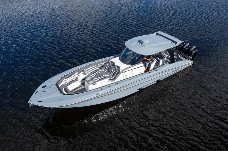 Slide: The Image of 2020 MTI V42 boat cruising on calm water, showcasing sleek design and powerful engines. - 63