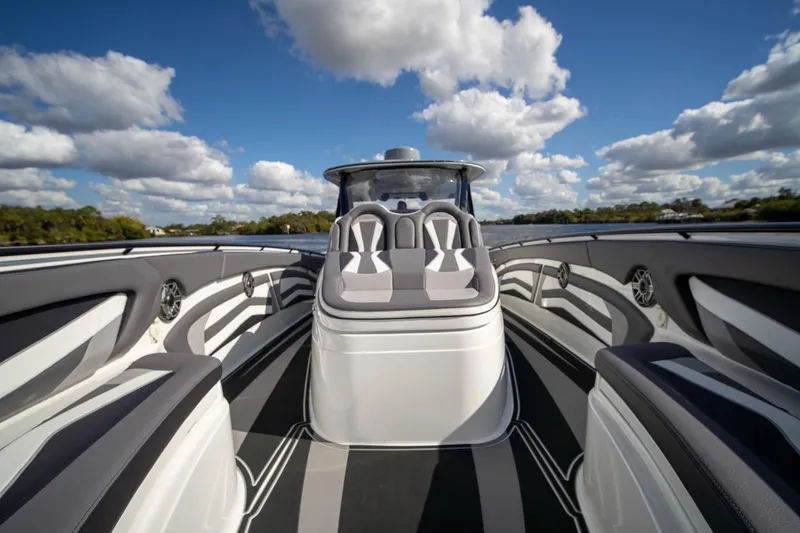 Slide: The Image of Luxury MTI V42 boat interior with sleek seating, under a bright blue sky. - 7