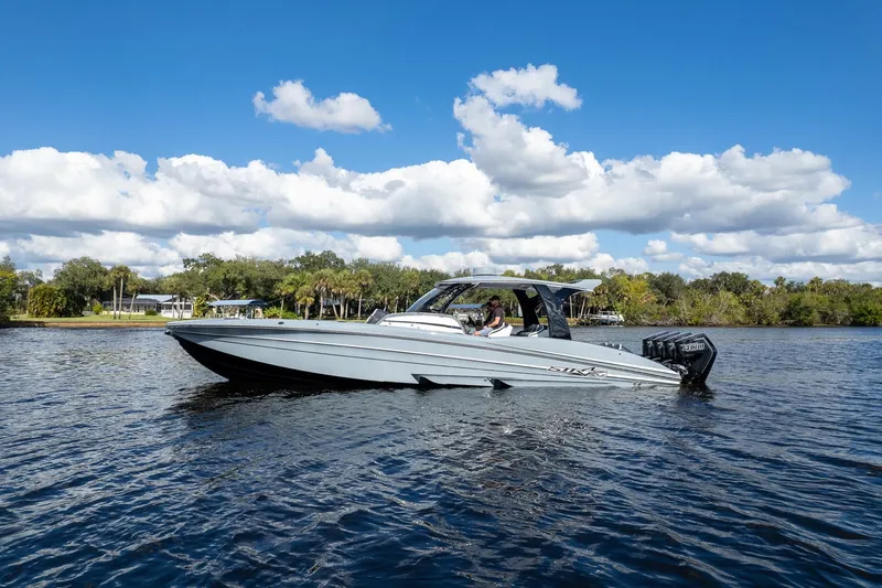 Slide: The Image of 2020 MTI V42 boat cruising on a sunny day with scenic background. - 73
