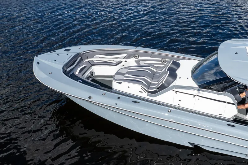 Slide: The Image of 2020 MTI V42 boat with sleek design and spacious seating on calm water. - 77