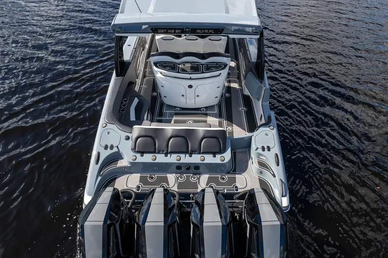 Slide: The Image of 2020 MTI V42 boat with sleek design and powerful engines on open water. - 80