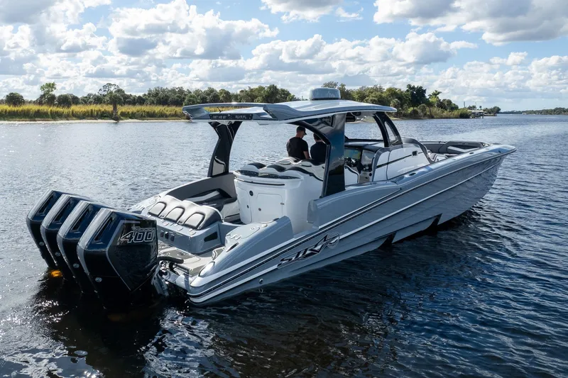 Slide: The Image of 2020 MTI V42 boat with quad engines cruising on a scenic lake. - 83