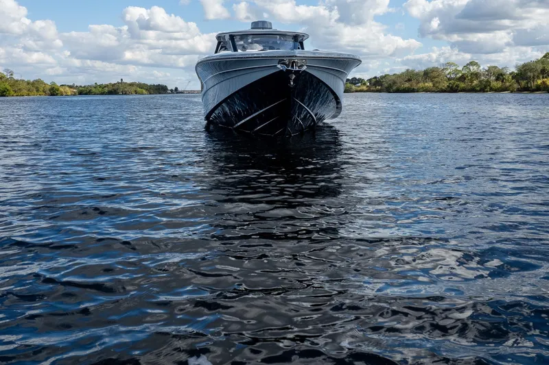 Slide: The Image of MTI V42 boat on a calm lake under a cloudy sky, 2020 model. - 88