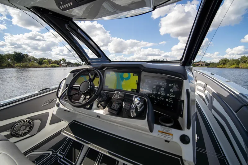 Slide: The Image of Cockpit view of 2020 MTI V42 boat with advanced navigation system and scenic waterway. - 9