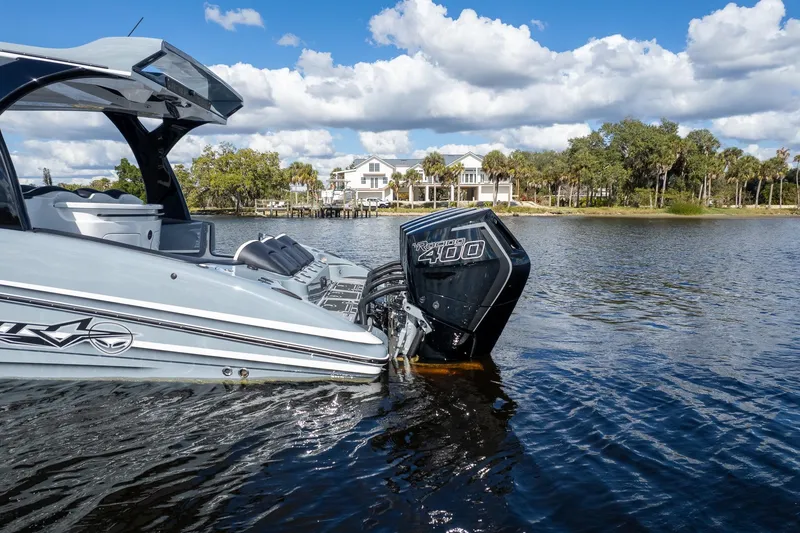 Slide: The Image of Luxury MTI V42 boat with powerful outboard engine on scenic waterfront. - 95